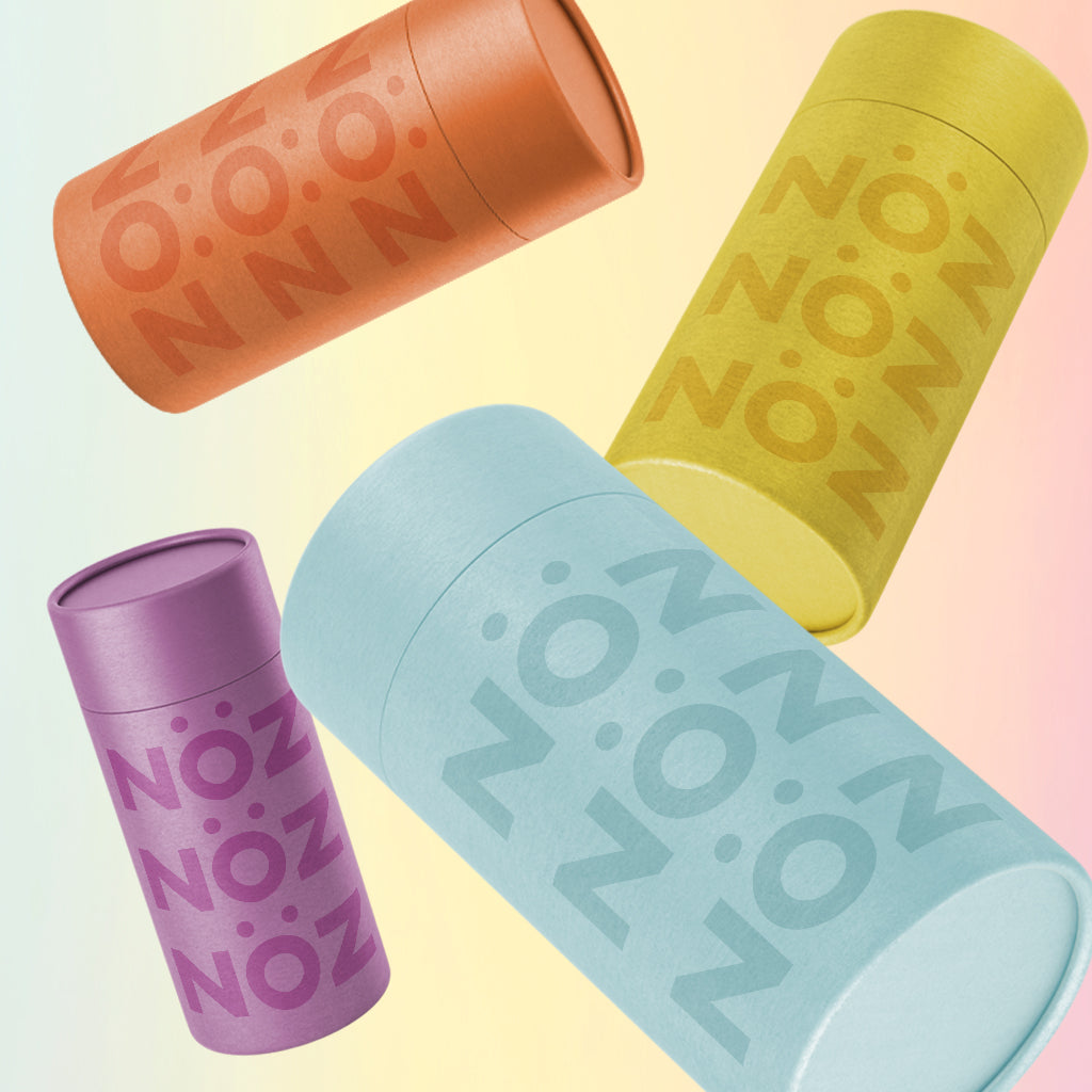 Light blue, yellow, orange, purple sunscreen sticks in a falling motion